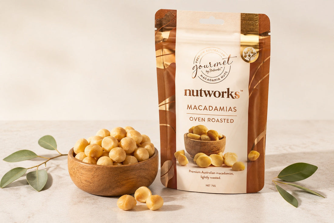 Oven roast Nutworks packaging close to a wooden full of macadamiabowl 