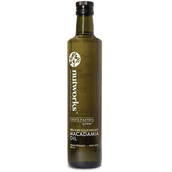 A bottle of macadamia oil 500 ml with a label that includes the brand name 'Nutworks' and the product name 'Macadamia Oil'. The bottle is dark glass with a white label and green text.