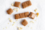 Macadamia Caramel fudge squares with nuts on a white background from Nutworks