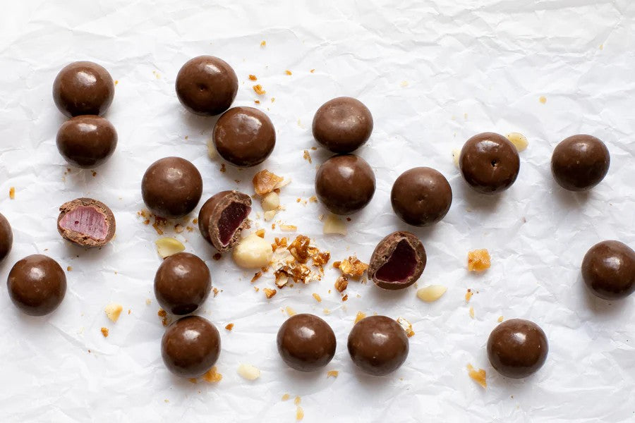 Milk Chocolate raspberry with nuts on a white surface photo from Nutworks