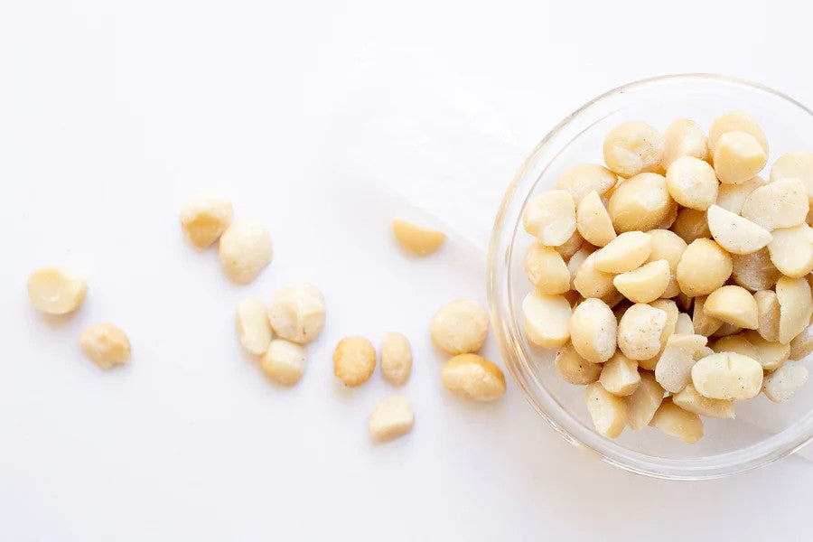Macadamia nuts in a glass bowl on a white background photo from Nutworks