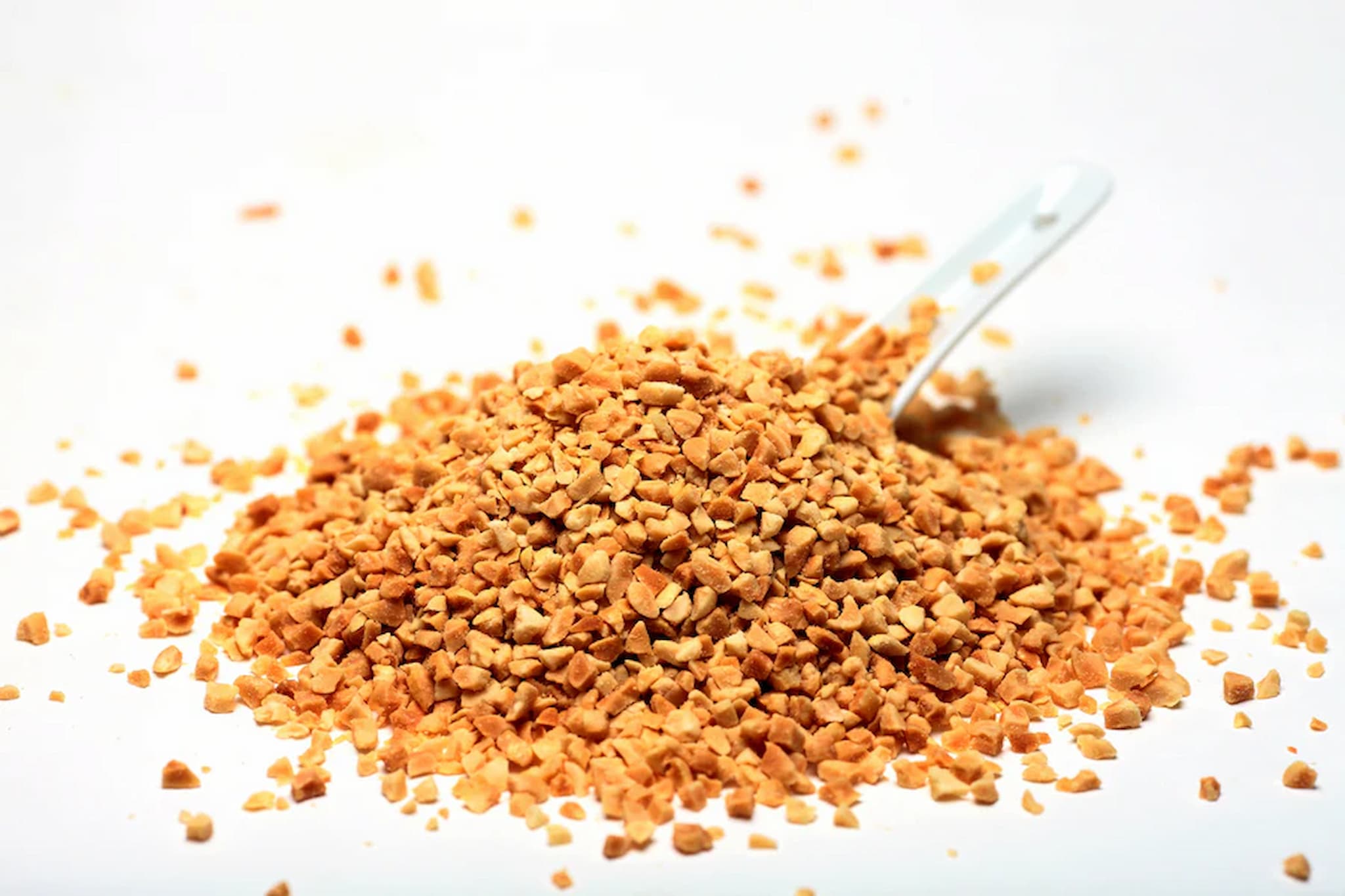 Pile of crushed peanuts on a white background photo from Nutworks