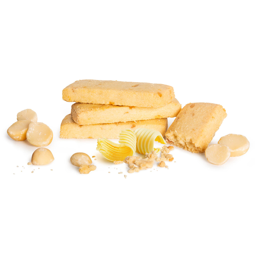 Stack of Macadamia Shortbread cookies with visible macadamia nuts and crumbled cookie pieces on a white  background from Nutworks.