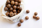 Macadamia nuts in a cloth bag on a white background photo from Nutworks