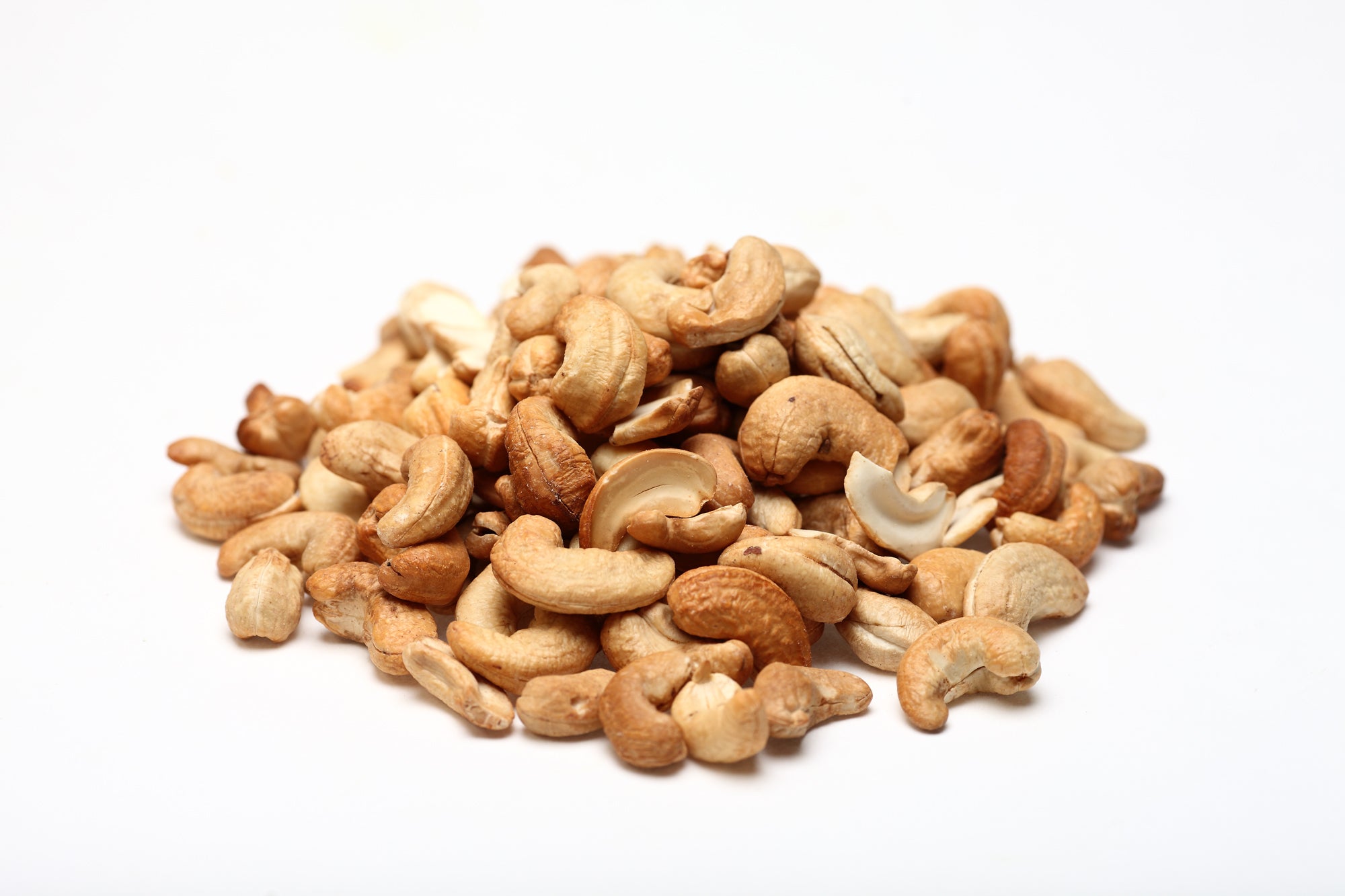 A pile of dry roasted cashew nuts without salt on a white background photo from Nutworks.