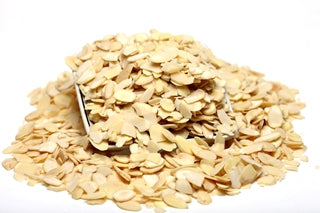 A pile of flaked almonds on a white background from Nutworks.